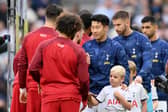Liverpool and Tottenham players shake hands prior to a Premier League fixture.