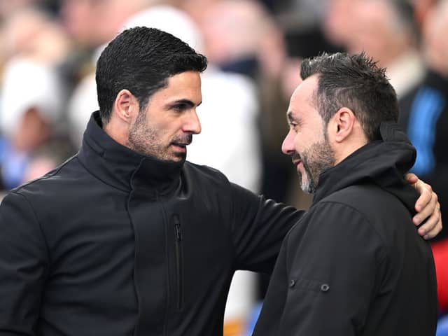 Mikel Arteta, Manager of Arsenal, interacts with Roberto De Zerbi, Manager of Brighton & Hove Albion