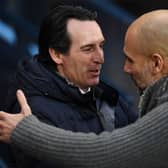 Manchester City's Spanish manager Pep Guardiola (R) greets Aston Villa's Spanish head coach Unai Emery
