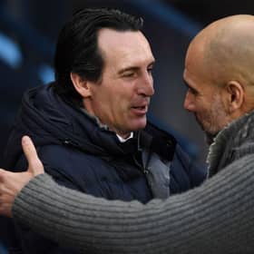 Manchester City's Spanish manager Pep Guardiola (R) greets Aston Villa's head coach Unai Emery