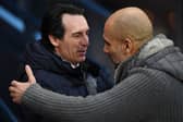 Manchester City's Spanish manager Pep Guardiola (R) greets Aston Villa's Spanish head coach Unai Emery