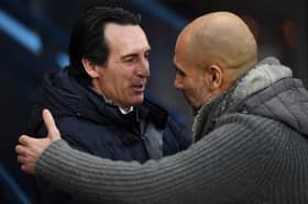Manchester City's Spanish manager Pep Guardiola (R) greets Aston Villa's Spanish head coach Unai Emery