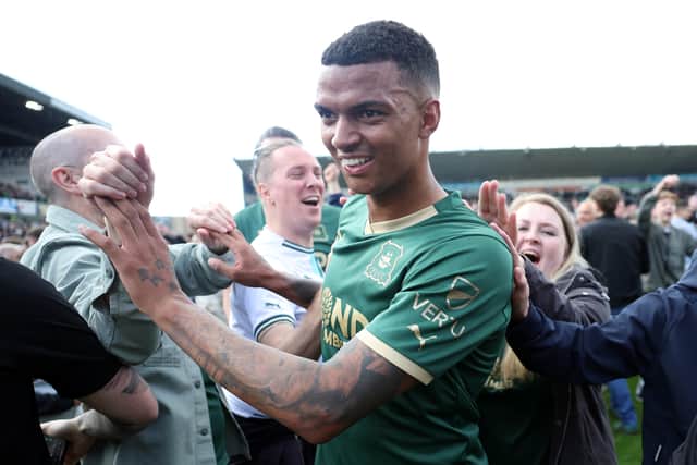 Morgan Whittaker of Plymouth Argyle celebrates victory with fans as they invade the pitch after avoiding relegation last season