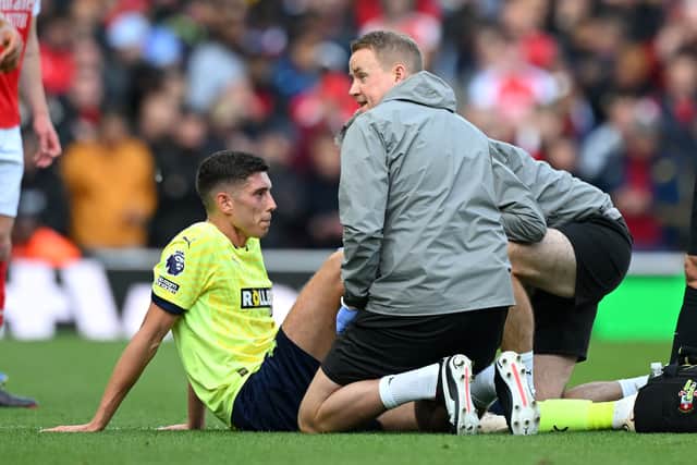 Ross Stewart of Southampton receives medical treatment during the Premier League match against Arsenal at Emirates Stadium on October 05, 2024 in London, England. (Photo by Clive Mason/Getty Images)