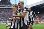 Anthony Gordon of Newcastle United celebrates with Bruno Guimaraes after scoring his team's first goal during the Premier League match between Newcastle United FC and Aston Villa FC at St James' Park on December 26, 2024 in Newcastle upon Tyne, England. (Photo by Stu Forster/Getty Images)