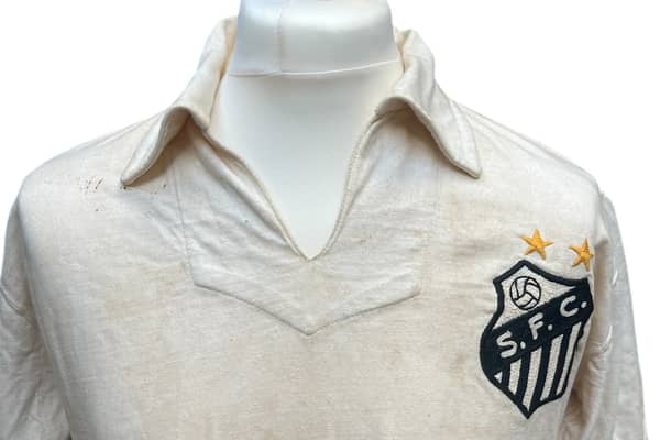 The football shirt worn by Pele when he scored his landmark 1,000th career goal is set to sell at auction for as much as £400,000. 