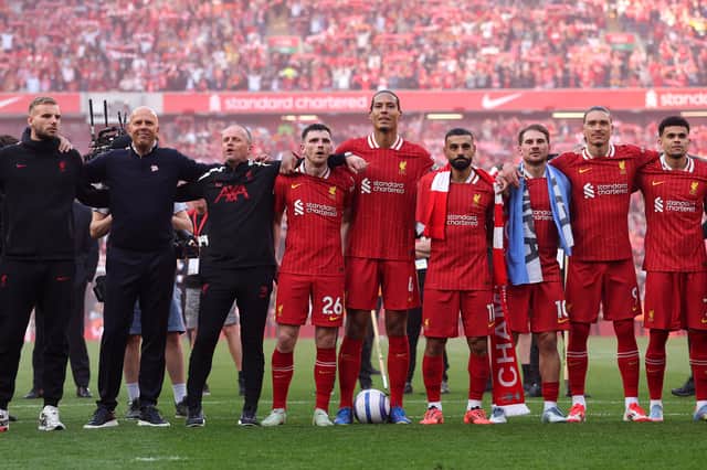 Vitezslav Jaros, Arne Slot, Manger of Liverpool, Sipke Hulshoff, assistant Manager of Liverpool, Andrew Robertson, Virgil van Dijk, Mohamed Salah, Alexis Mac Allister, Darwin Nunez and Luis Diaz celebrate with the fans after confirmation of winning the Premier League title in the Premier League match between Liverpool FC and Tottenham Hotspur FC at Anfield on April 27, 2025 in Liverpool, England. (Photo by Carl Recine/Getty Images)