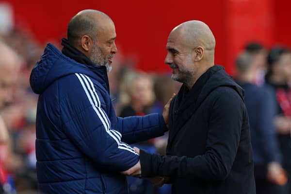 Nottingham Forest's Portuguese manager Nuno Espirito Santo (L) greets Manchester City's Spanish manager Pep Guardiola (R) ahead of kick-off in the Premier League. (Photo by DARREN STAPLES/AFP via Getty Images)     