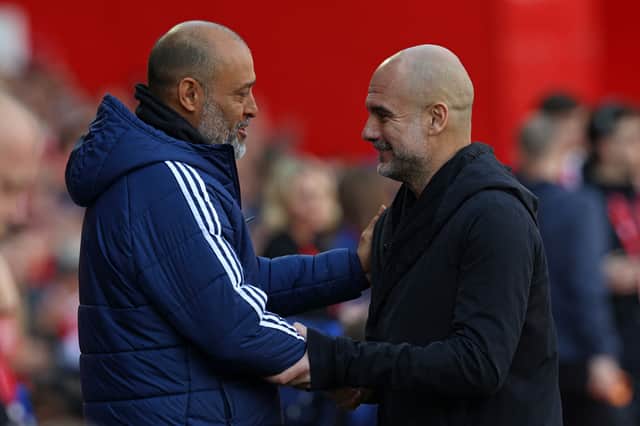 Nottingham Forest's Portuguese manager Nuno Espirito Santo (L) greets Manchester City's Spanish manager Pep Guardiola (R) ahead of kick-off in the Premier League. (Photo by DARREN STAPLES/AFP via Getty Images)