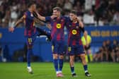 Robert Lewandowski celebrates with his Barcelona teammates | Alex Caparros/Getty Images