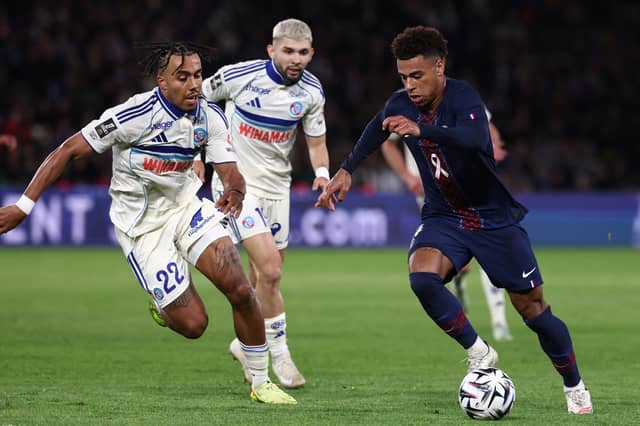 Guela Doue of Strasbourg battles his brother and PSG winger Desire Doue in Ligue 1 | FRANCK FIFE/AFP via Getty Images