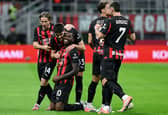 Rafael Leao celebrates with his AC Milan teammates after scoring in Serie A | Stefano RELLANDINI / AFP / Getty Images