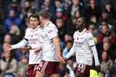 Viktor Gyokeres celebrates with Martin Zubimendi Eberech Eze after his Premier League goal against Burnley | Stuart MacFarlane/Arsenal FC via Getty Images