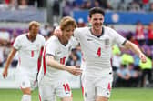 Anthony Gordon celebrates with Declan Rice after combining for England's opener