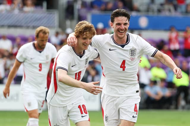 Anthony Gordon celebrates with Declan Rice after combining for England's opener