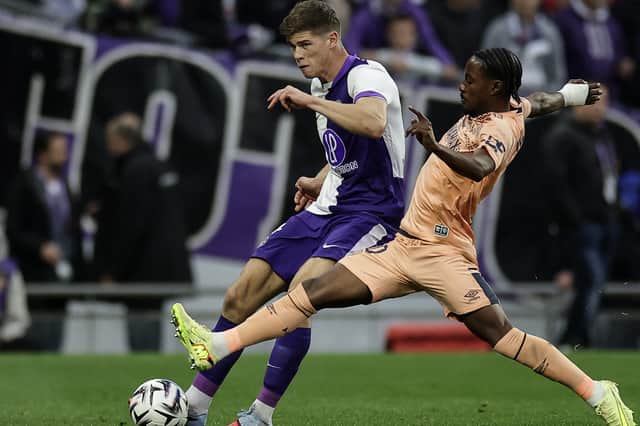 Cresswell holds of the challenge of Le Havre's Felix Mambimbi