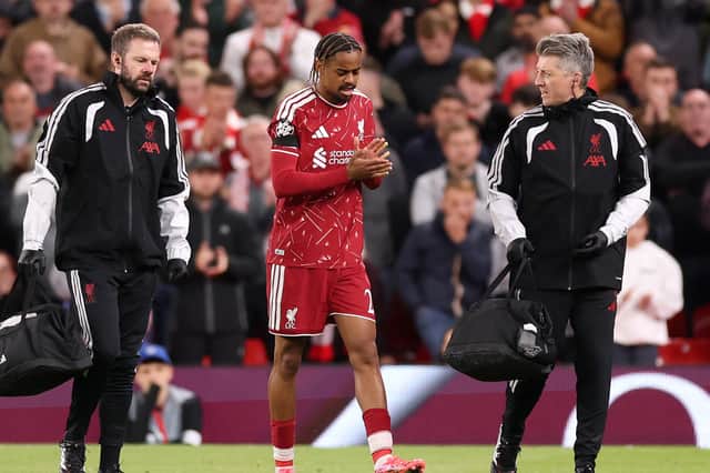 Liverpool's medical team walk Bradley Barcola from the field an hour into his debut