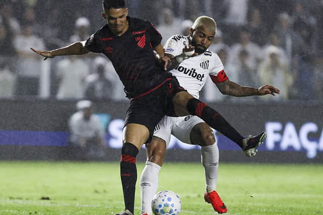 Dias (left) battles with Santos' Gabriel Barbosa