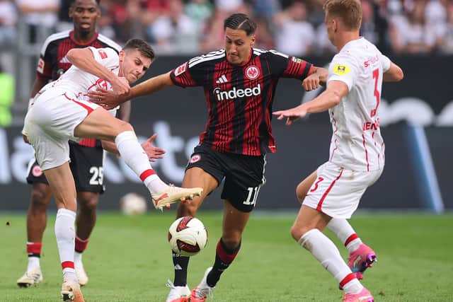 Ebnoutalib squirms between two Freiburg players in a recent Bundesliga game
