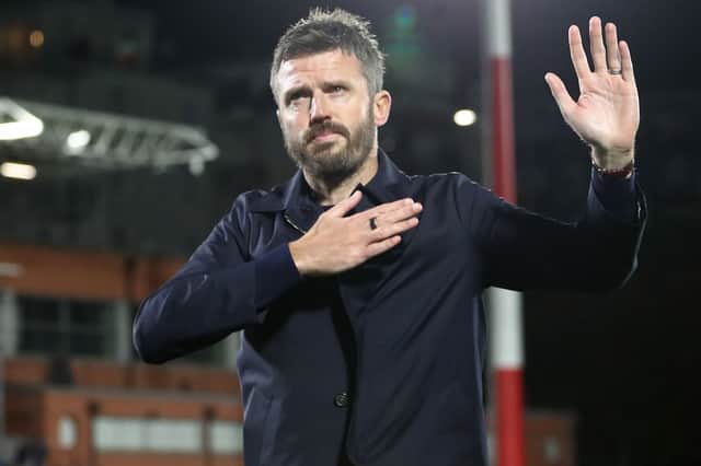Carrick appears to apologise to the travelling fans after the 4-1 loss to Como in the Champions League