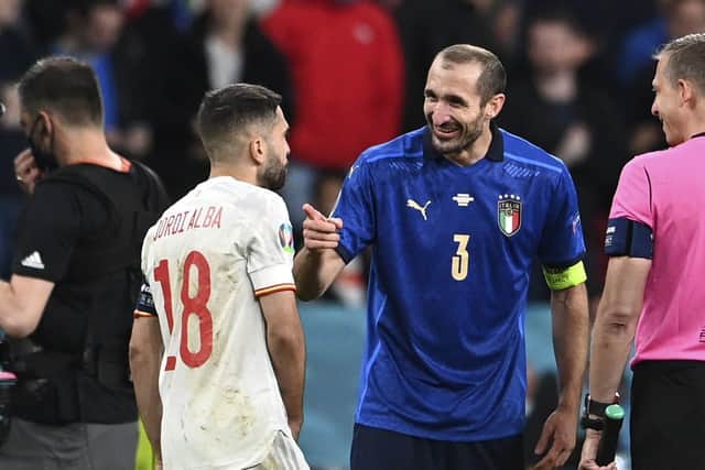 Italy's Giorgio Chiellini, 2nd left, talks to Spain's Jordi Alba, left, before the penalty shootout of the Euro 2020 semi-final. (Andy Rain/Pool via AP)