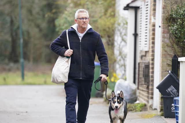 Match Of The Day host Gary Lineker returns to his home in London with his dog.