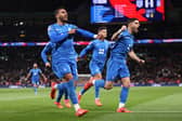 Vangelis Pavlidis Greece celebrates scoring his team's first goal as he gestures towards his black armband in honour of the passing of former Greek player George Baldock