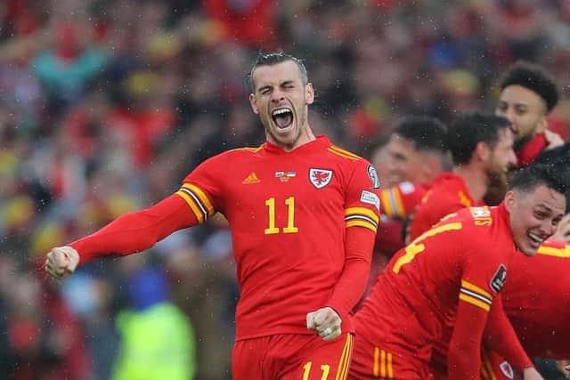 Wales' striker Gareth Bale (L) celebrates with teammates after winning the FIFA World Cup 2022 play-off final against Ukraine. (Photo by GEOFF CADDICK/AFP via Getty Images)