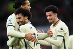 Mohamed Salah of Liverpool celebrates after scoring their side's fourth goal with Virgil van Dijk during the Premier League match between Manchester United and Liverpool at Old Trafford on October 24, 2021 in Manchester, England. (Photo by Michael Regan/Getty Images)