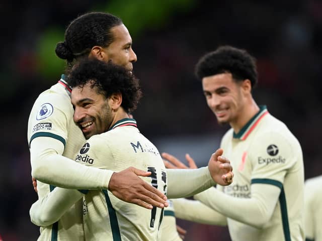 Mohamed Salah of Liverpool celebrates after scoring their side's fourth goal with Virgil van Dijk during the Premier League match between Manchester United and Liverpool at Old Trafford on October 24, 2021 in Manchester, England. (Photo by Michael Regan/Getty Images)