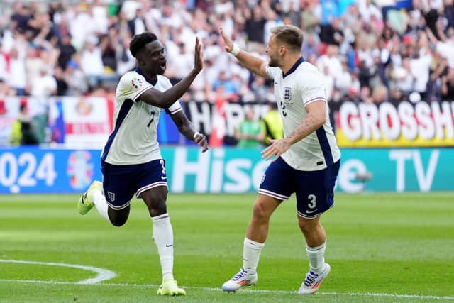 BACK IN THE GAME: England's Bukayo Saka (left) celebrates with Luke Shaw after scoring England's equaliser against Switzerland on Saturday. Picture: Bradley Collyer/PA