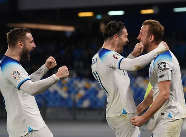 NAPLES, ITALY - MARCH 23: Harry Kane of England celebrates with team mates Luke Shaw and Jack Grealish of England after scoring their sides second goal during the UEFA EURO 2024 qualifying round group C match between Italy and England at Stadio Diego Armando Maradona on March 23, 2023 in Naples, Italy. (Photo by Michael Regan/Getty Images)