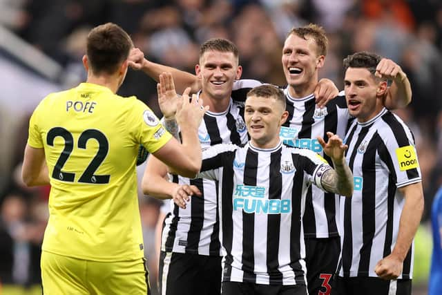 NEWCASTLE UPON TYNE, ENGLAND - OCTOBER 19: Nick Pope of Newcastle United joins in with the celebrations as team mates Sven Botman, Kieran Trippier, Dan Burn and Fabian Schar celebrates their side's win after the final whistle of the Premier League match between Newcastle United and Everton FC at St. James Park on October 19, 2022 in Newcastle upon Tyne, England. (Photo by George Wood/Getty Images)