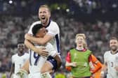 England's Harry Kane celebrates in the arms of team-mate Ollie Watkins at the end of a semifinal match between the Netherlands and England. (AP Photo/Martin Meissner).