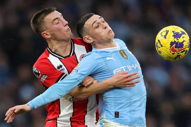 HOLDING ON: Luke Thomas challenges Phil Foden