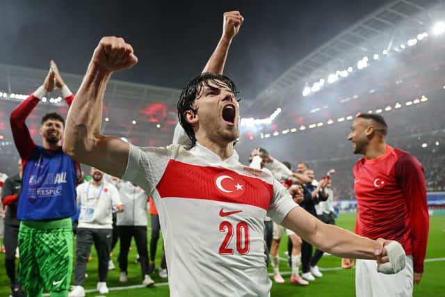 LEIPZIG, GERMANY - JULY 02: Ferdi Kadioglu of Turkiye celebrates victory with teammates in front of his fans after defeating Austria during the UEFA EURO 2024 round of 16 match between Austria and Turkiye at Football Stadium Leipzig on July 02, 2024 in Leipzig, Germany. (Photo by Dan Mullan/Getty Images)