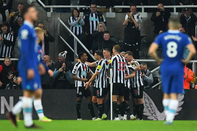 Newcastle United's English midfielder Joe Willock celebrates scoring his team's first goal with teammates during the English Premier League football match between Newcastle United and Chelsea at St James' Park in Newcastle-upon-Tyne, north east England on November 12, 2022. (Photo by ANDY BUCHANAN/AFP via Getty Images)
